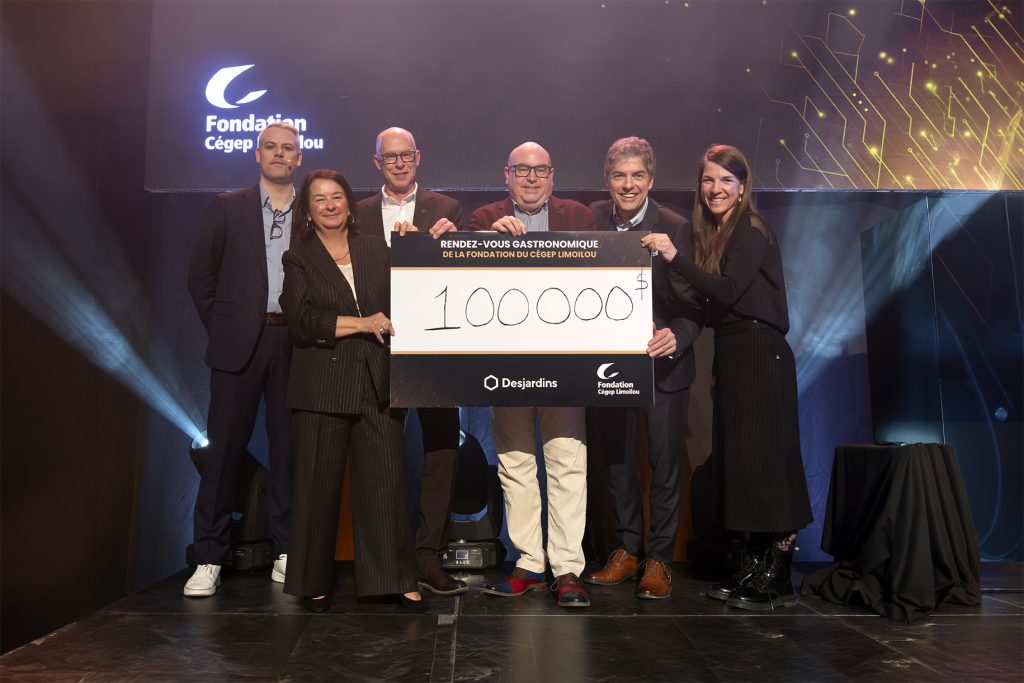 Équipe du Cégep Limoilou avec l'animateur de la soirée et les partenaires des Caisses populaires lors de la remise du chèque de 100 000$