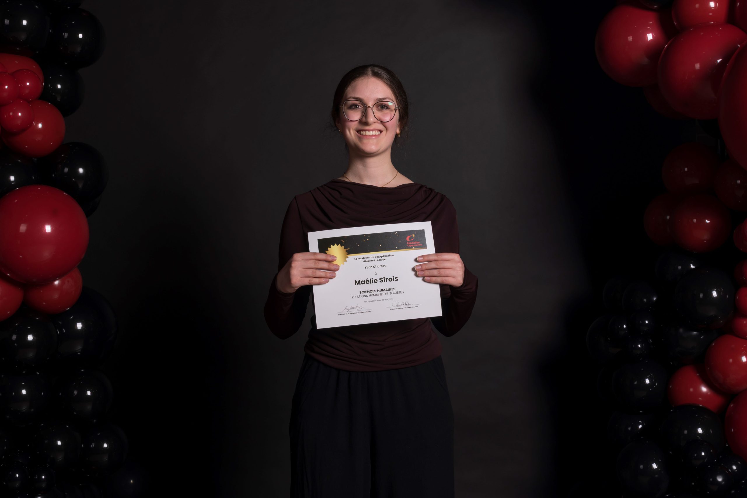 Maélie Sirois, souriante, et son certificat du Mérite étudiant 2026